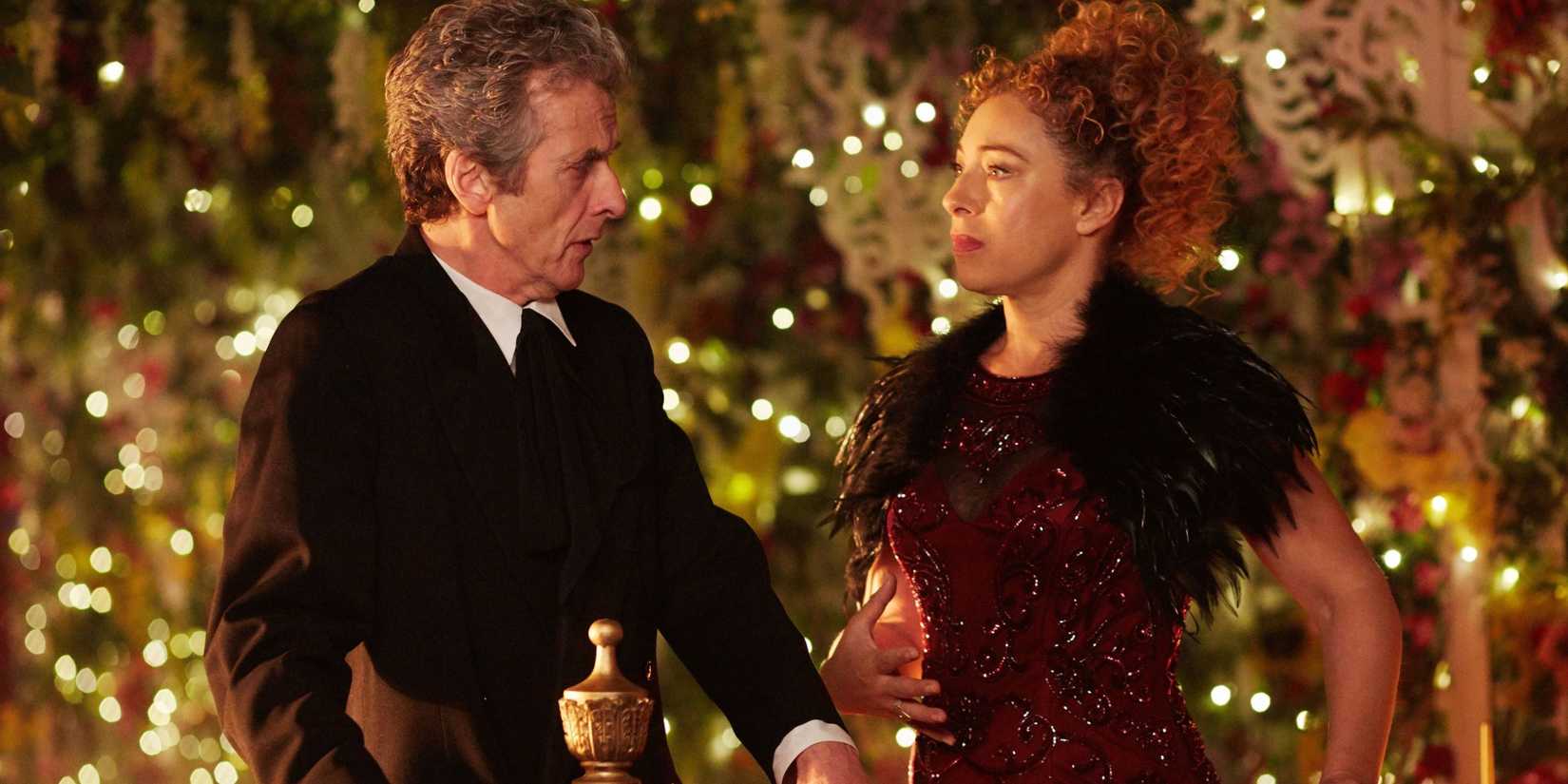 The Twelfth Doctor and River standing on a balcony before dinner on Darillium in the Doctor Who episode “The Husbands Of River Song.” 