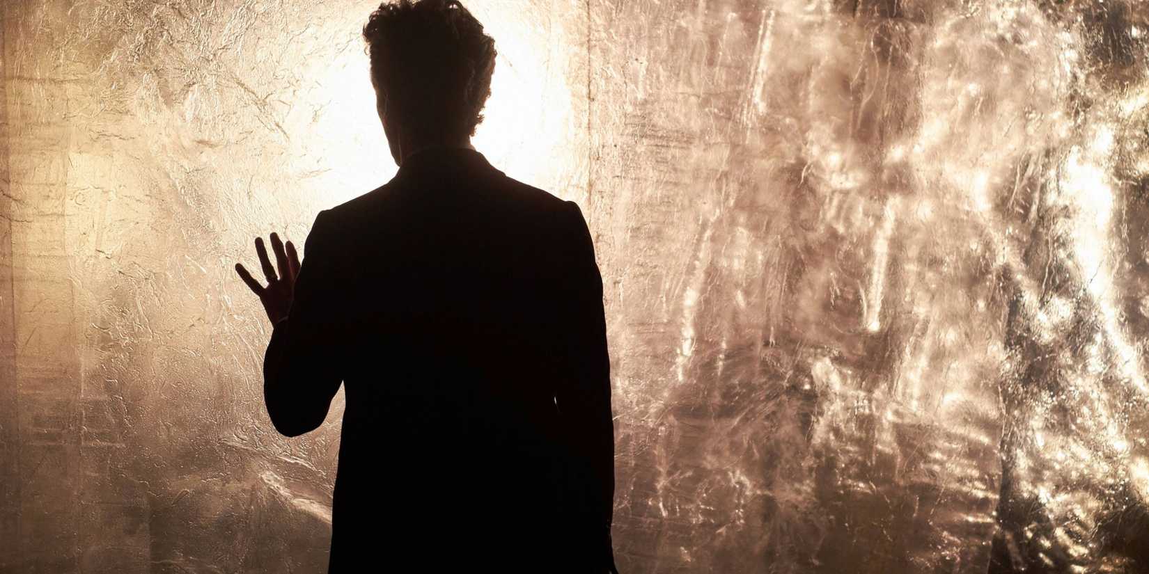 The Twelfth Doctor touching a wall made of diamonds, emotional, in the Doctor Who episode “Heaven Sent.” 