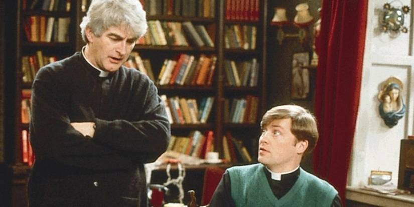 Dougal looking at Ted as he talks to him in their living room in Father Ted.