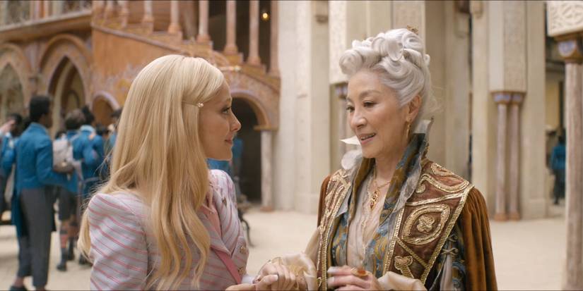 Glinda talking to Morrible about sorcery tutoring in the Shiz courtyard in Wicked.