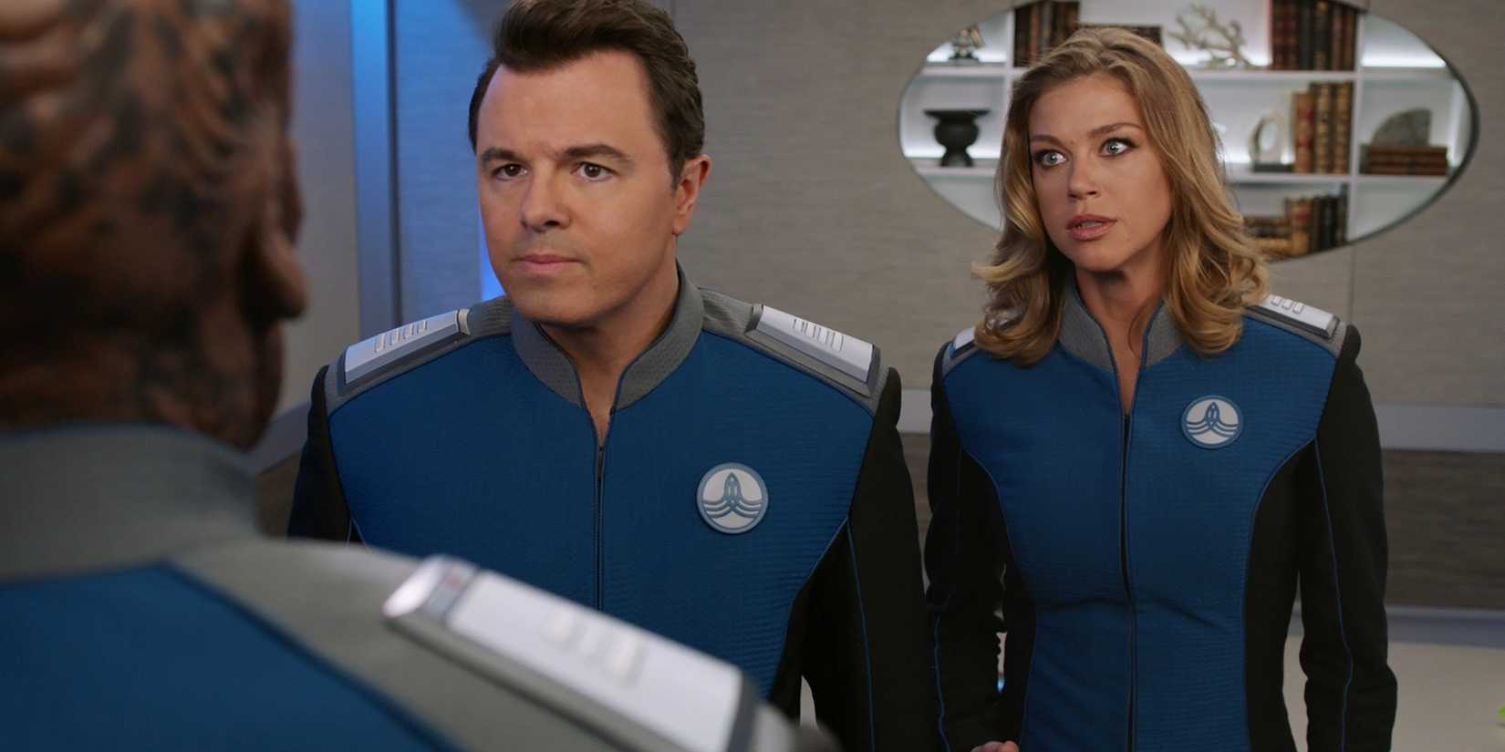 A stressed looking Commander Kelly Grayson and Captain Ed Mercer talking to Bortus in the hallway of the ship in The Orville.