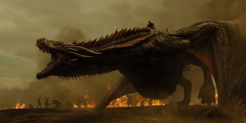 Daenerys rides a dragon as the ground burns around them in Game of Thrones