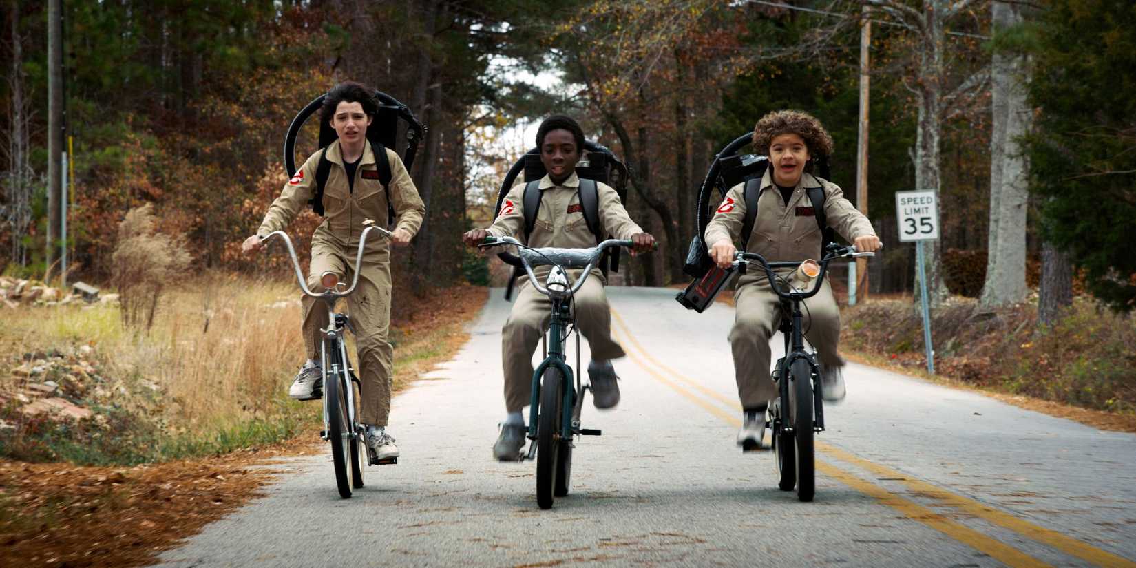 Mike, Lucas, and Dustin cycling down the road
