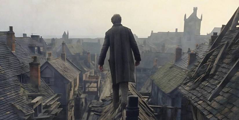 A man with his back to the camera looking at a ruined town in the TV show Gormenghast