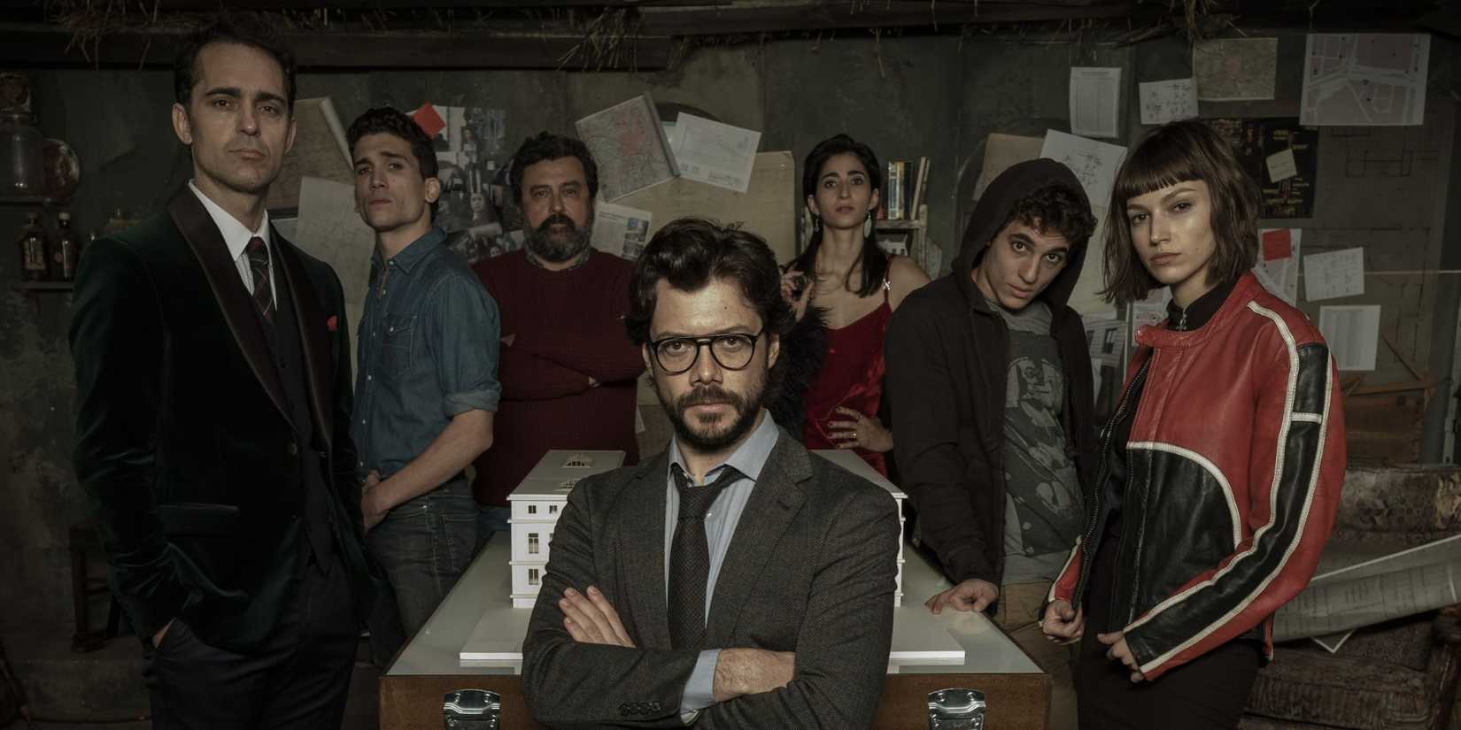 The Professor sitting in front of Berlin, Denver, Moscow, Nairobi, Rio, and Tokyo in Money Heist