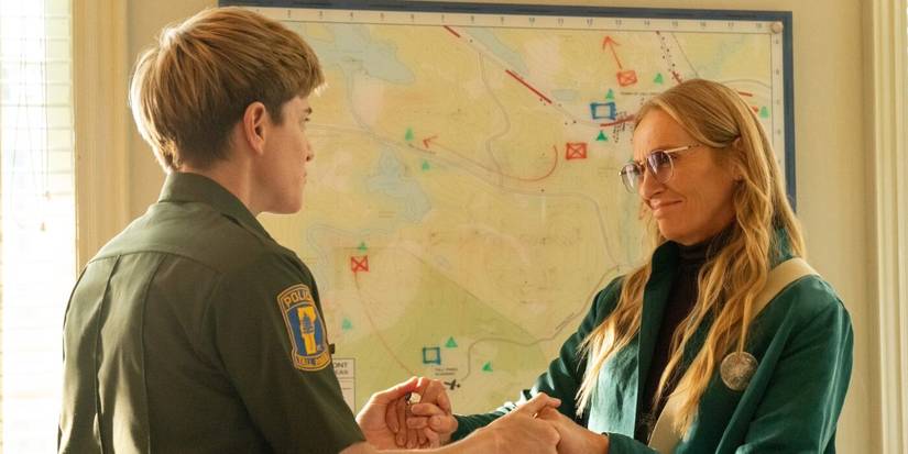 Alex holds hands with Evelyn while she smiles in Wayward