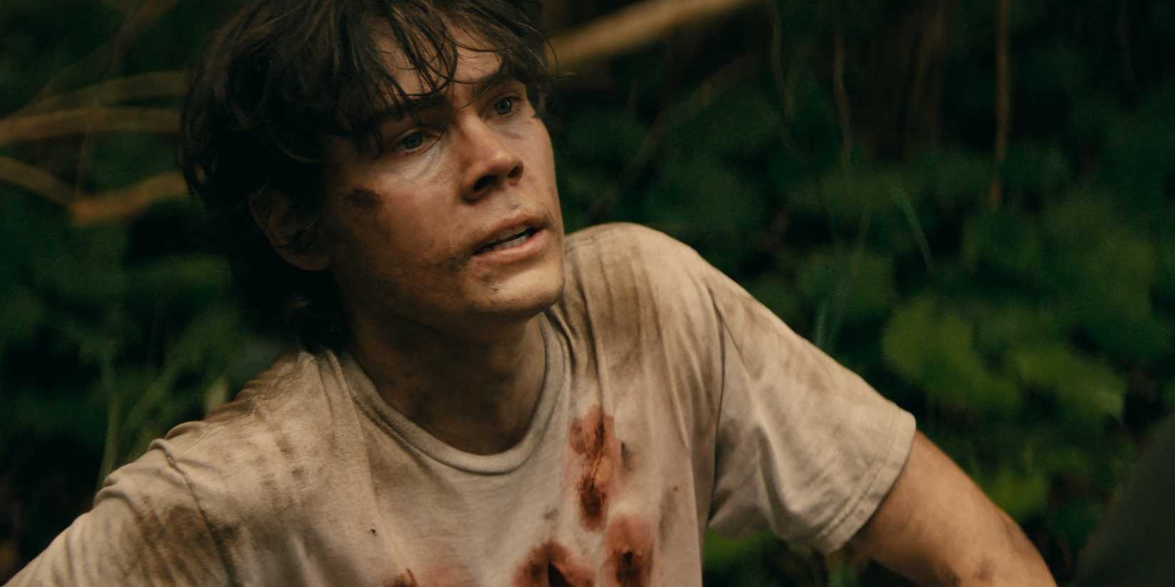 Riley is in the woods with a bloody shirt in Wayward episode 1