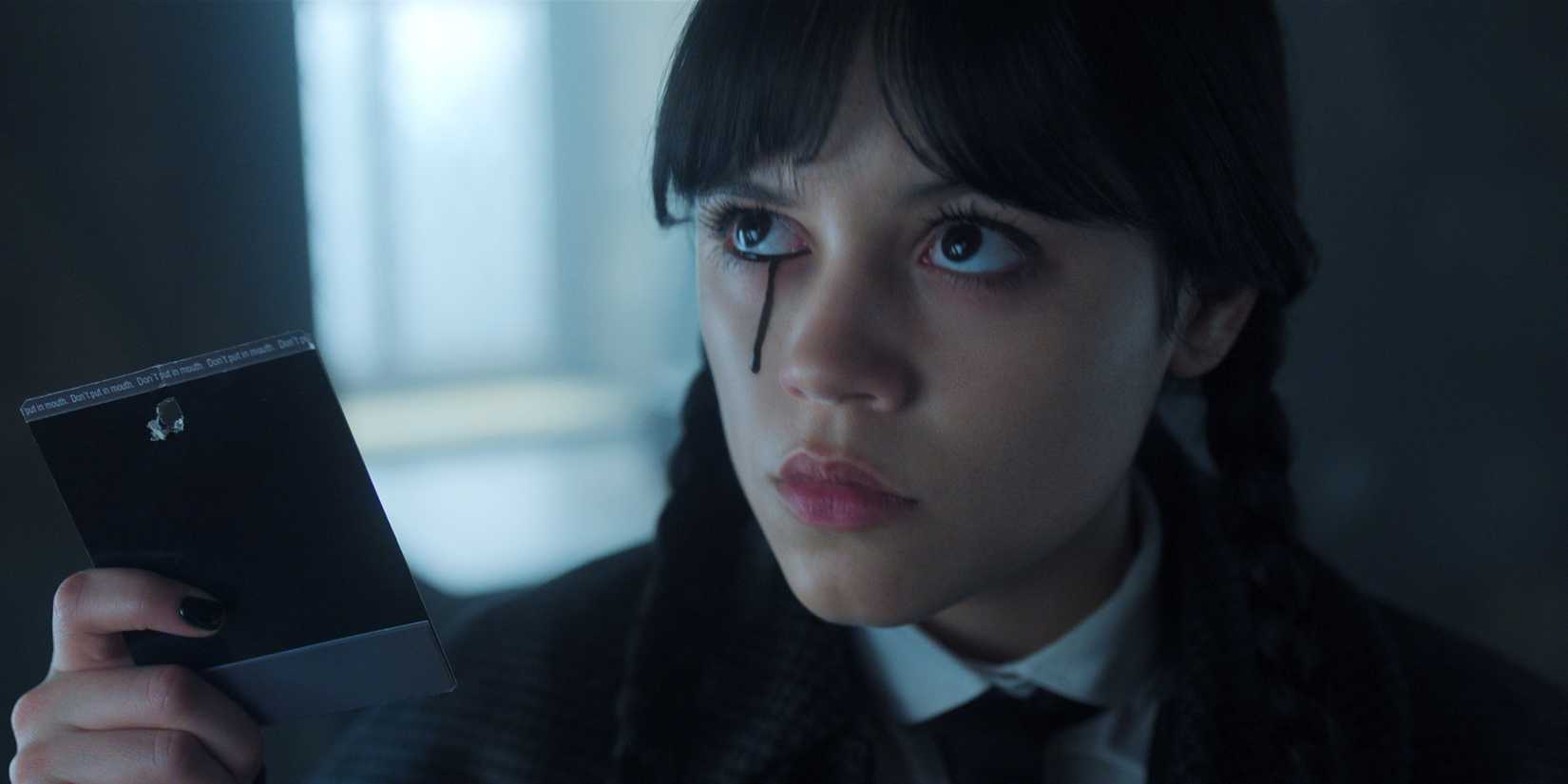 A black tear runs down Wednesday's face in Wednesday season 2