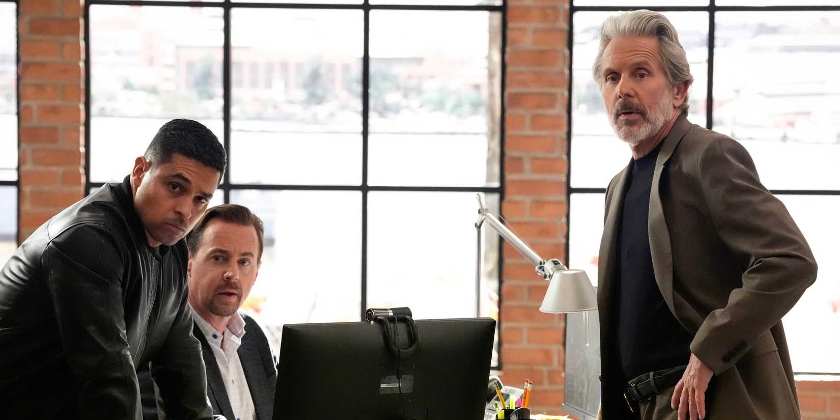 Wilmer Valderrama, Sean Murray, and Gary Cole posed near a computer from NCIS