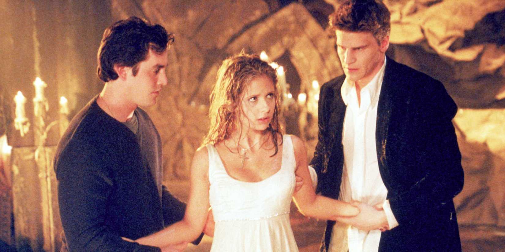 Xander and Angel holding up a recently drowned Buffy in Buffy the Vampire Slayer season 1 Prophecy Girl episode