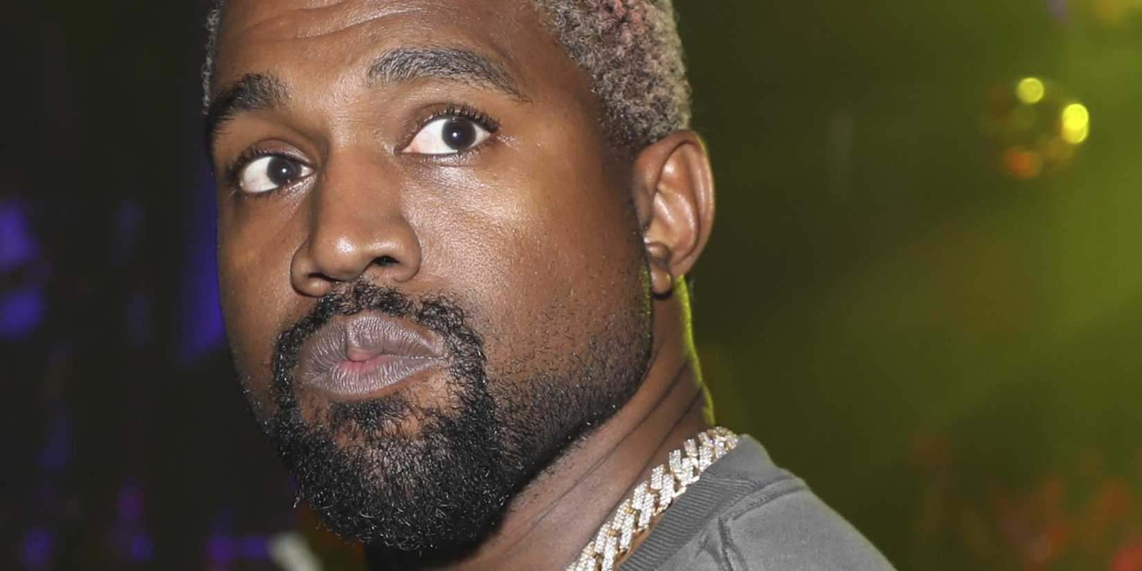 Kanye West wearing blonde hair in a close-up photo