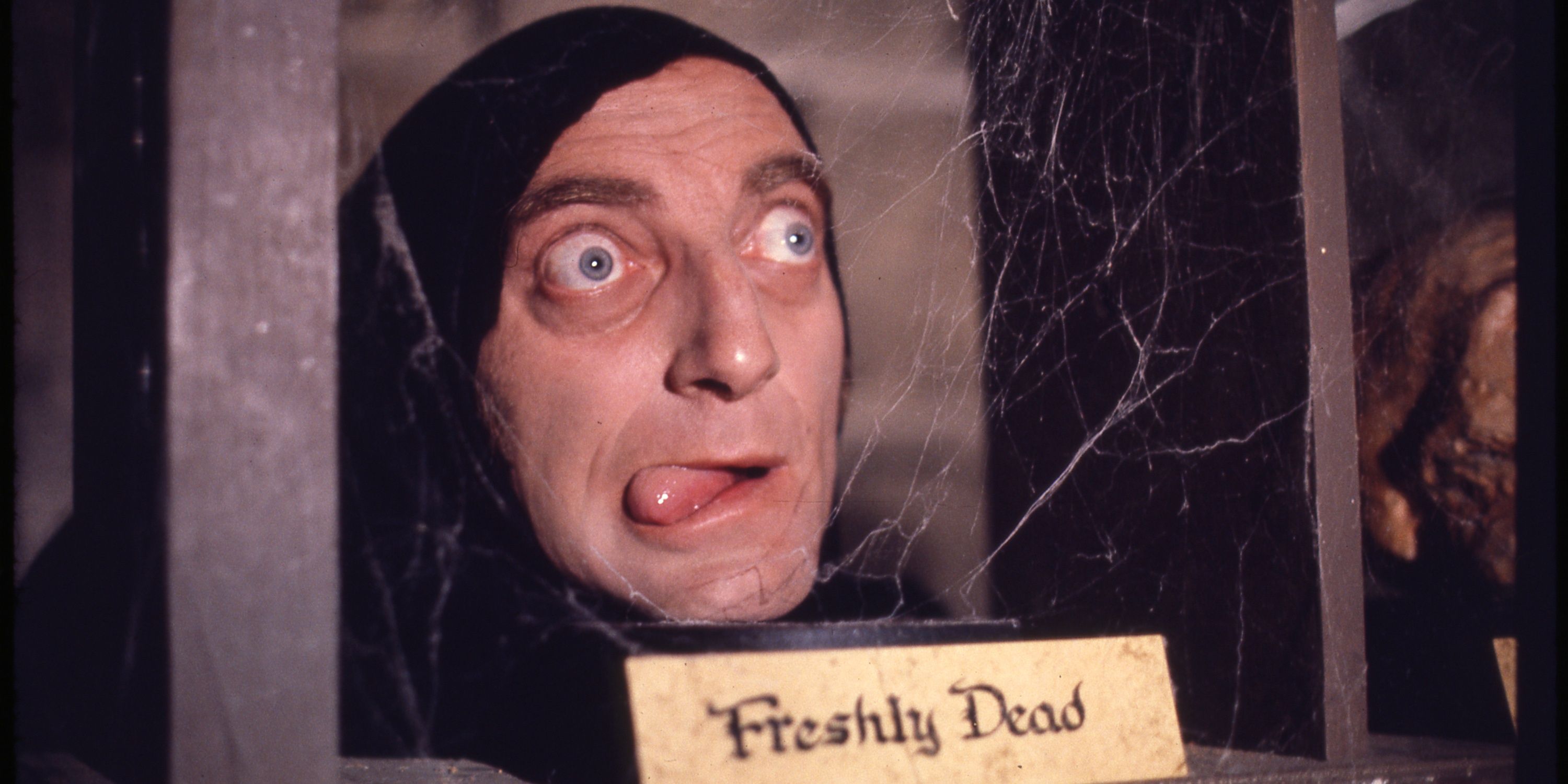 Igor with his tongue sticking out in front of a freshly dead sign in Young Frankenstein
