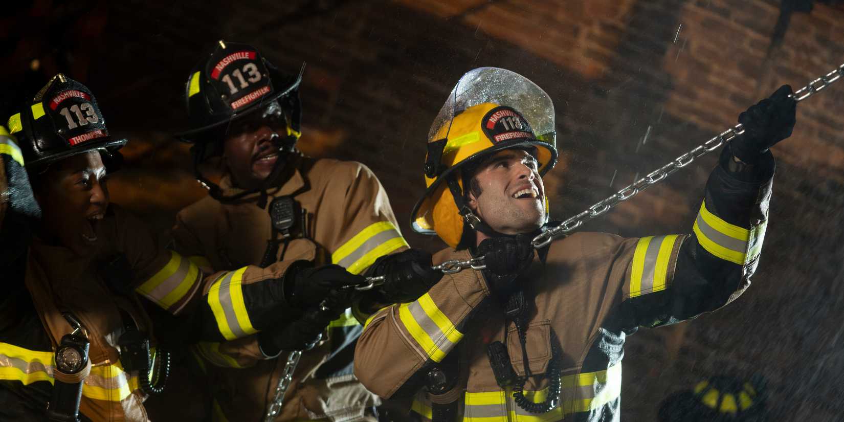 911 Nashville's 113 crew pulling a chain rope to assist in a disaster.