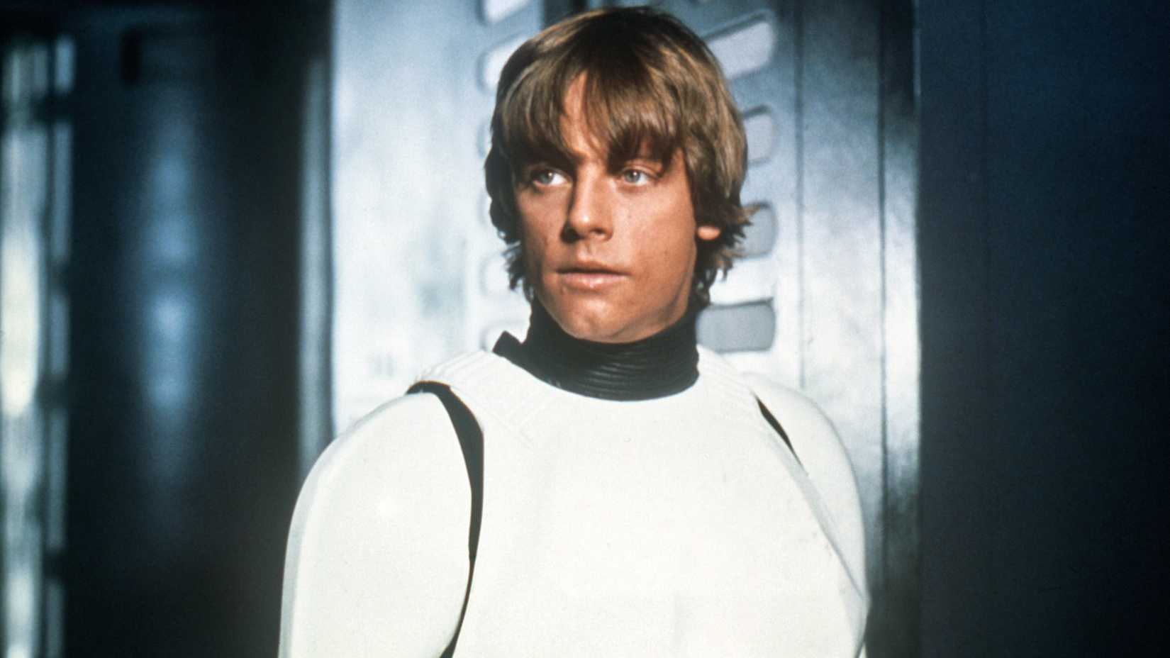 A mid-shot of Luke Skywalker in Stormtrooper gear with his helmet off in Star Wars A New Hope