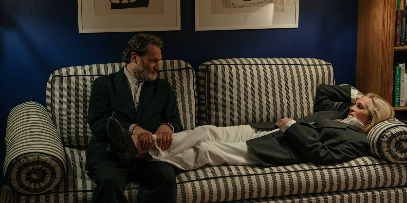 Alma lying down as Frederik massages her ankles in After the Hunt