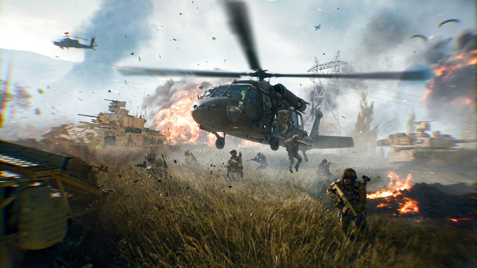 A Blackhawk helicopter in Battlefield 6, deploying infantry while armored vehicles drive nearby.