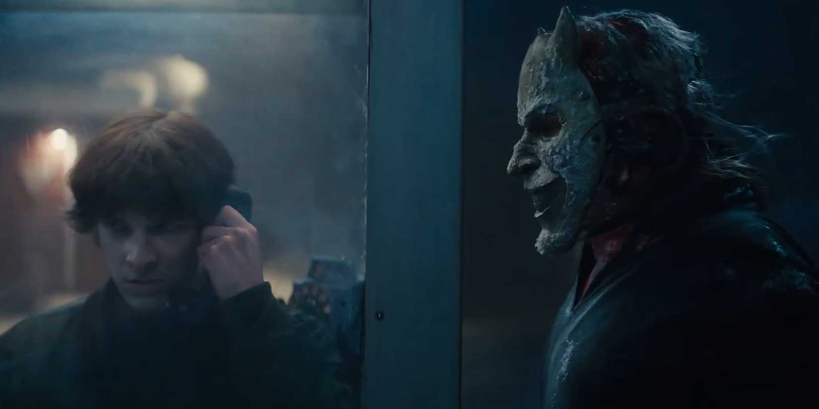 Mason Thames on the phone and Ethan Hawke as The Grabber standing outside in Black Phone 2