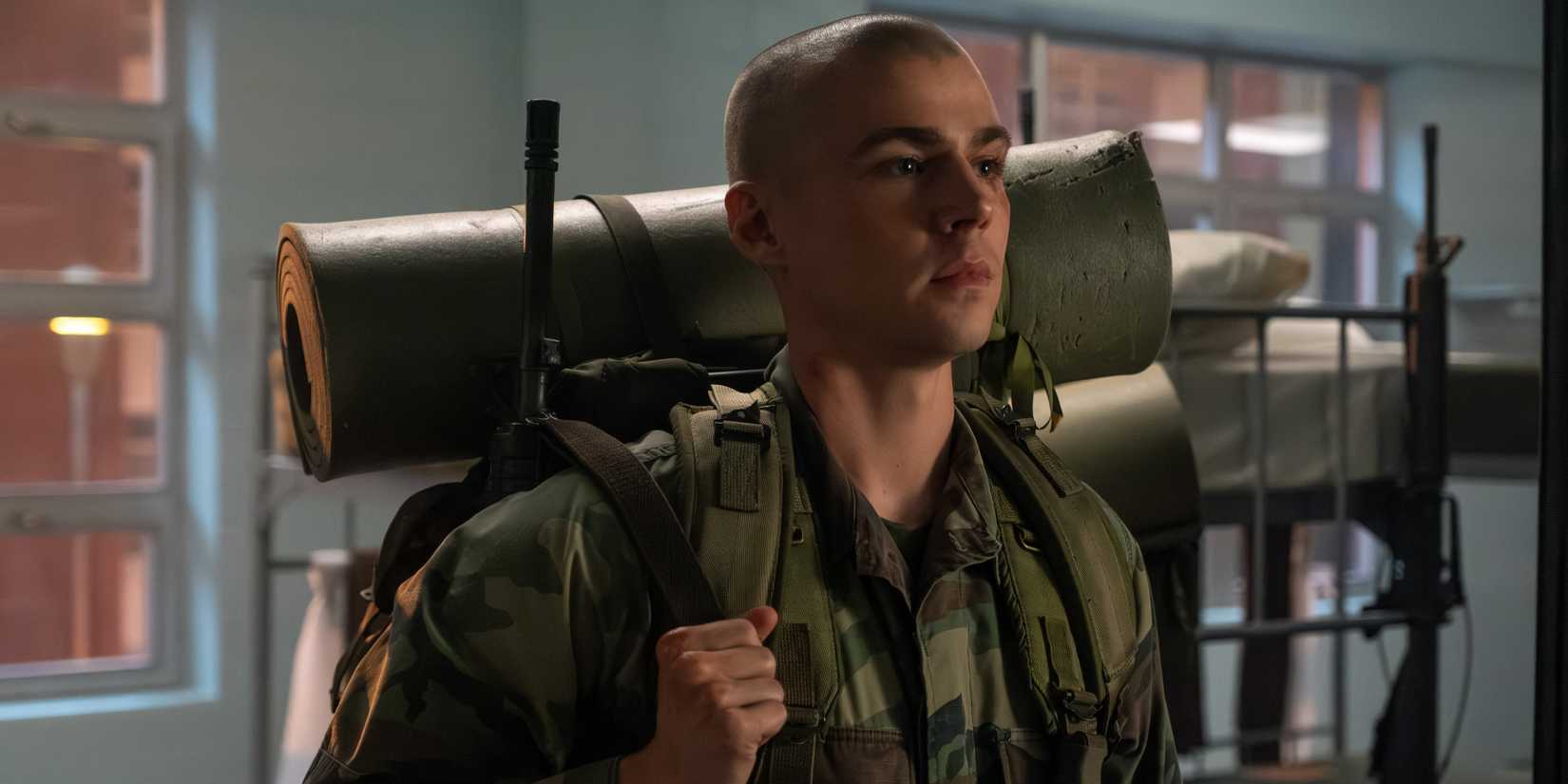 Cam holds his pack while in uniform in Boots episode 8