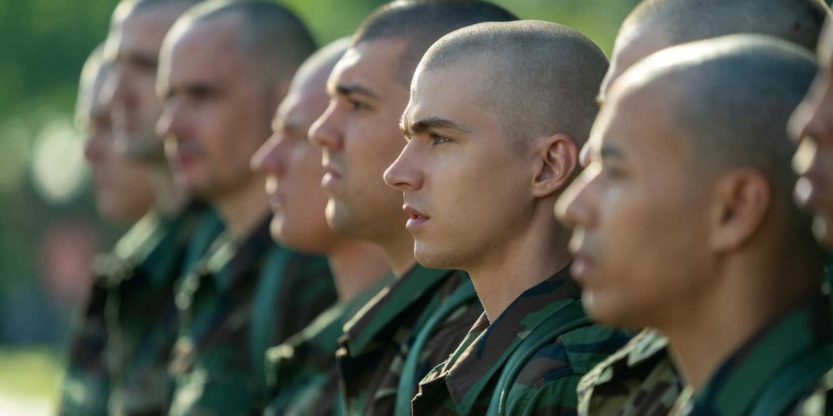 Cam stands at attention with his fellow recruits in Boots episode 1