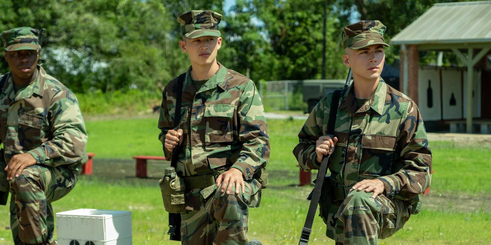 Ray and Cam take a knee while holding rifles in Boots episode 5.