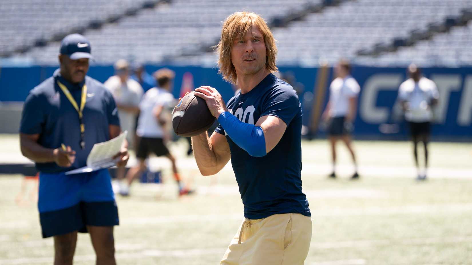Chad Powers (Glen Powell) preparing to throw a football in Chad Powers.