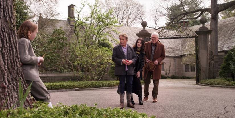 Charles, Oliver, and Mabel standing in front of a mansion talking to a young boy in Only Murders in the Building season 5, episode 7