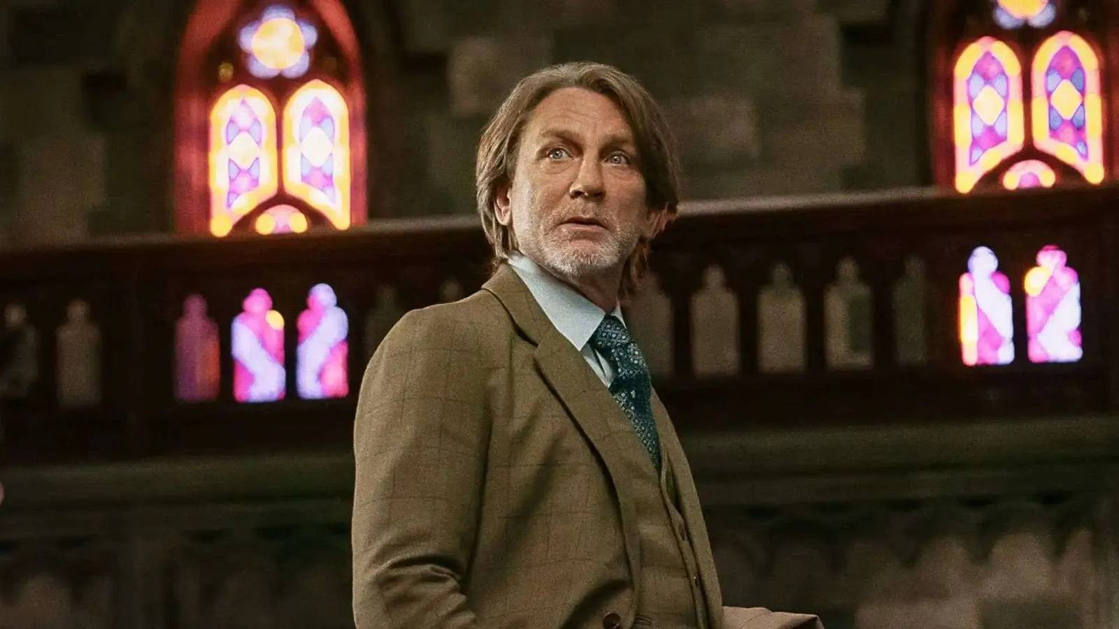 Daniel Craig looking curious in a church in Knives Out Wake Up Dead Man