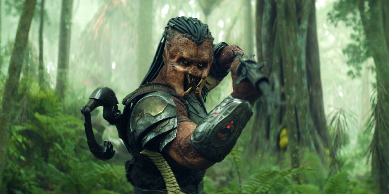 Dek holding a harpoon-like weapon on the forest in Predator Badlands