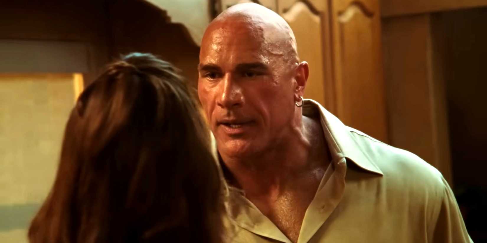 Dwayne Johnson's Mark Kerr looking angry while standing tall above Emily Blunt's Dawn in The Smashing Machine