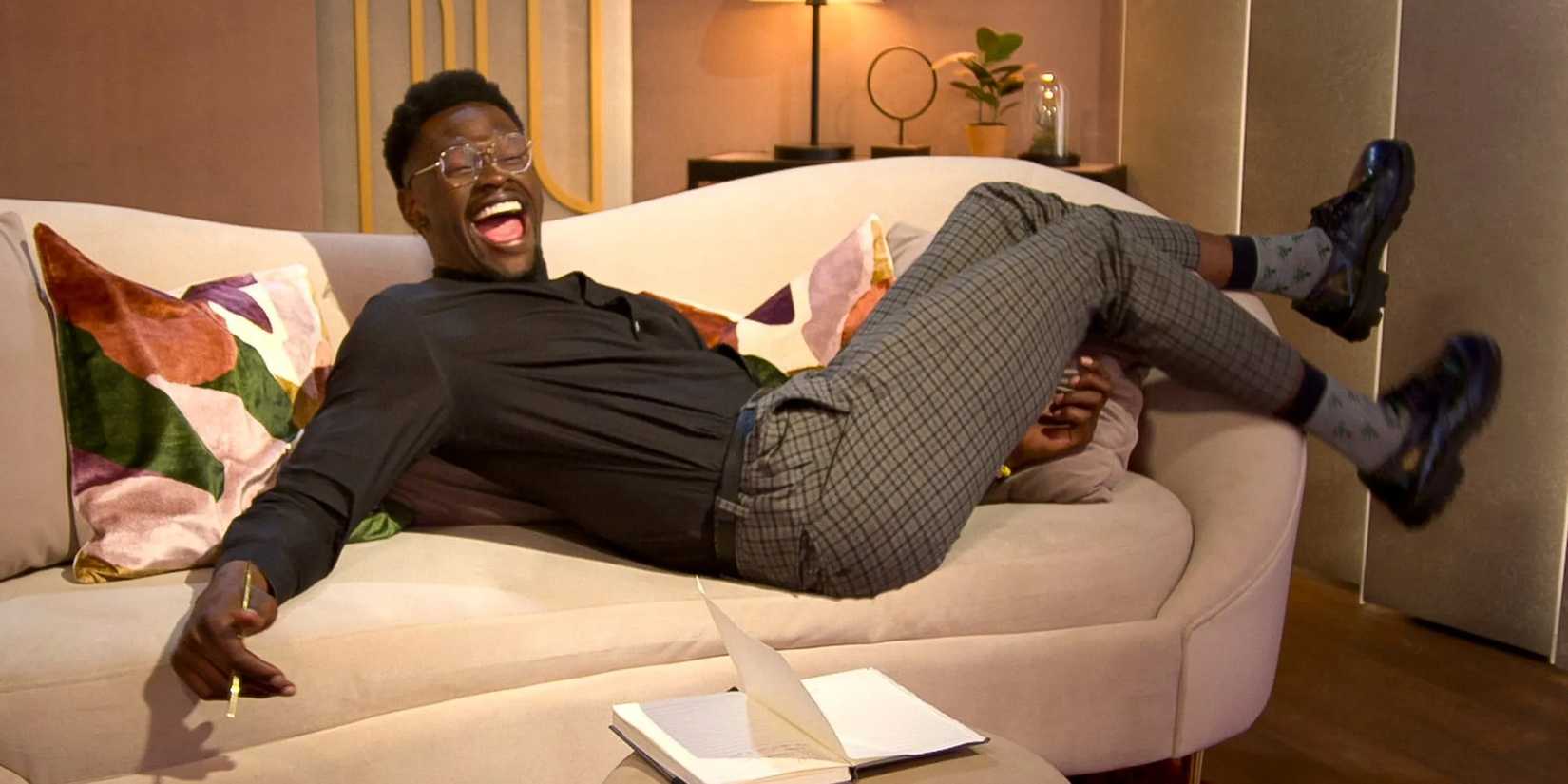 Edmond Harvey excitedly lays on a couch in the pods on Love Is Blind season 9