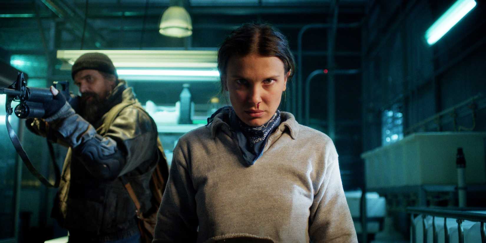 Eleven is staring while Hopper is next to her in Stranger Things season 5