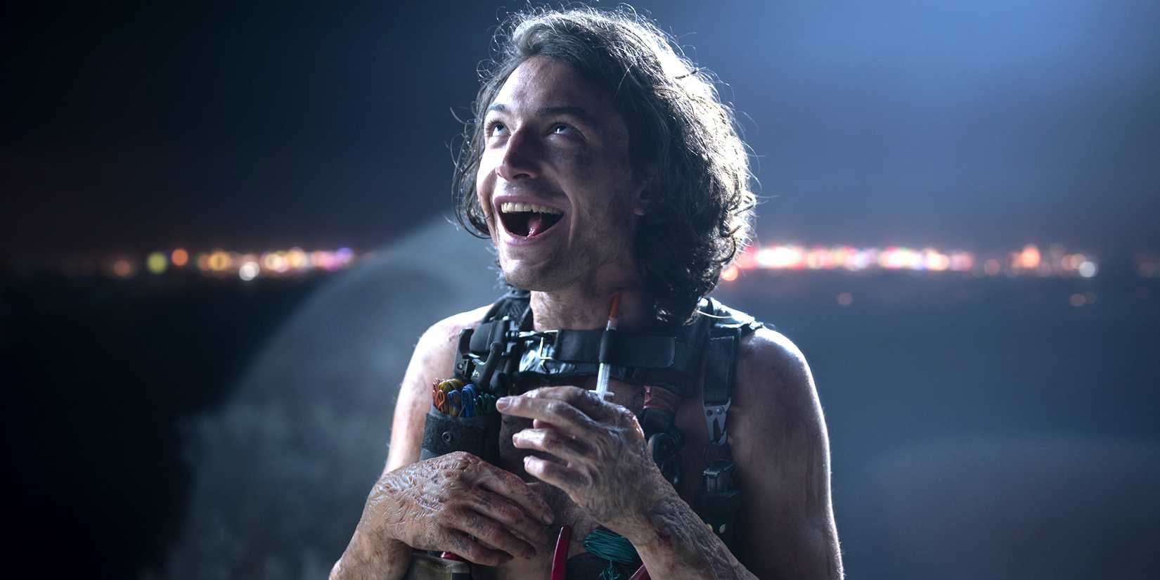Ezra Miller as The Traschan Man smiling deliriously in The Stand