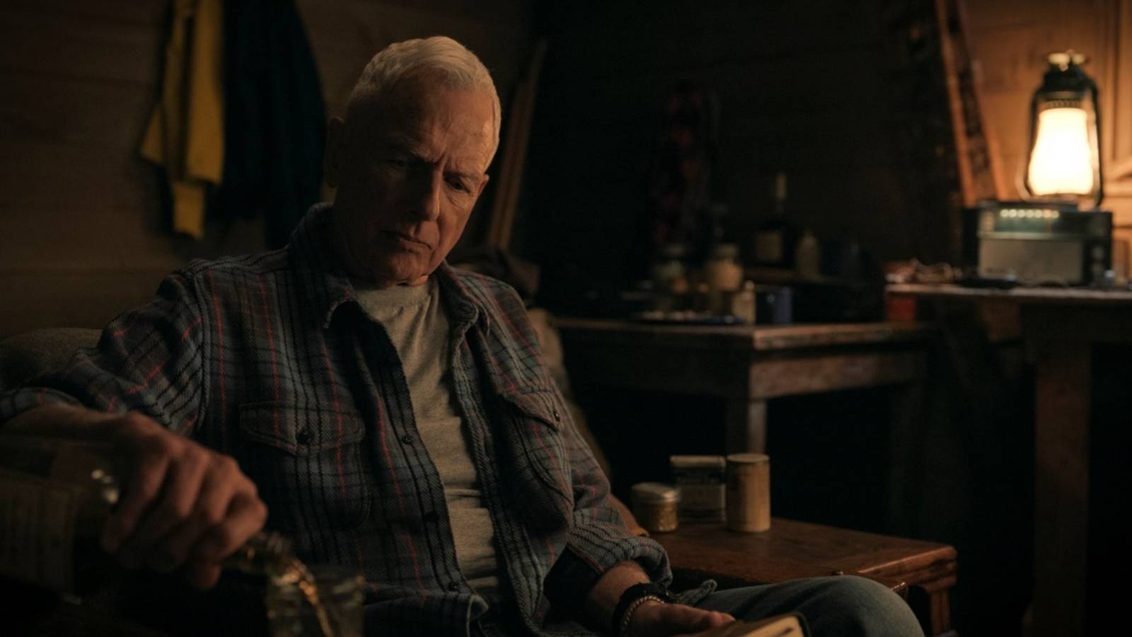 Gibbs sits on a couch in