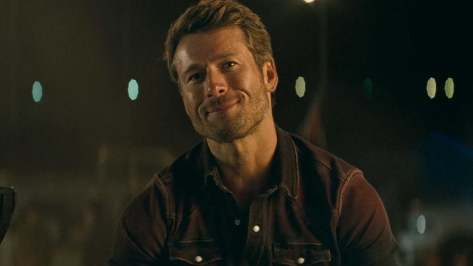 Glen Powell with a half smile in Twisters