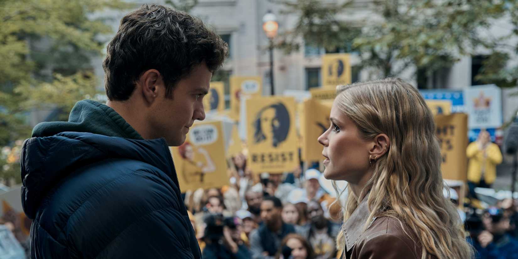 All Seasons Of The Boys & Gen V, Ranked Worst To Best Hughie (Jack Quaid) and Annie (Erin Moriarty) looking at each other in front of a Starlight protest in The Boys season 4