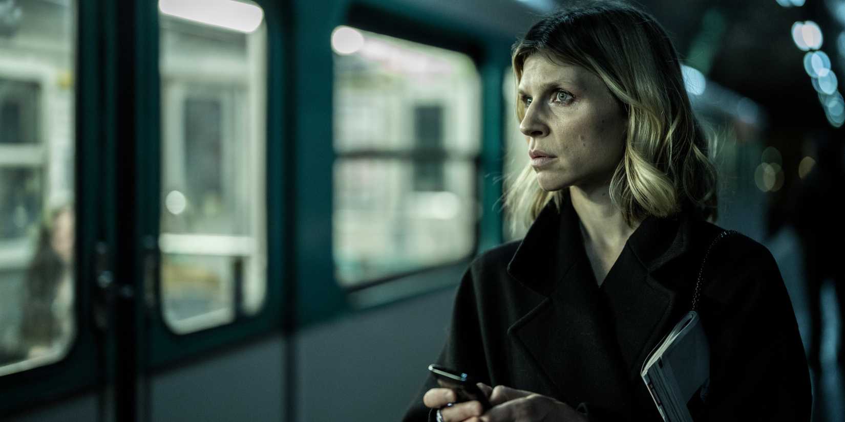 Clémence Poésy as Isabelle holding her phone while standing in front of a train in The Walking Dead: Daryl Dixon season 1
