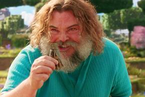 Jack Black as Steve excitedly holding up a small object in A Minecraft Movie