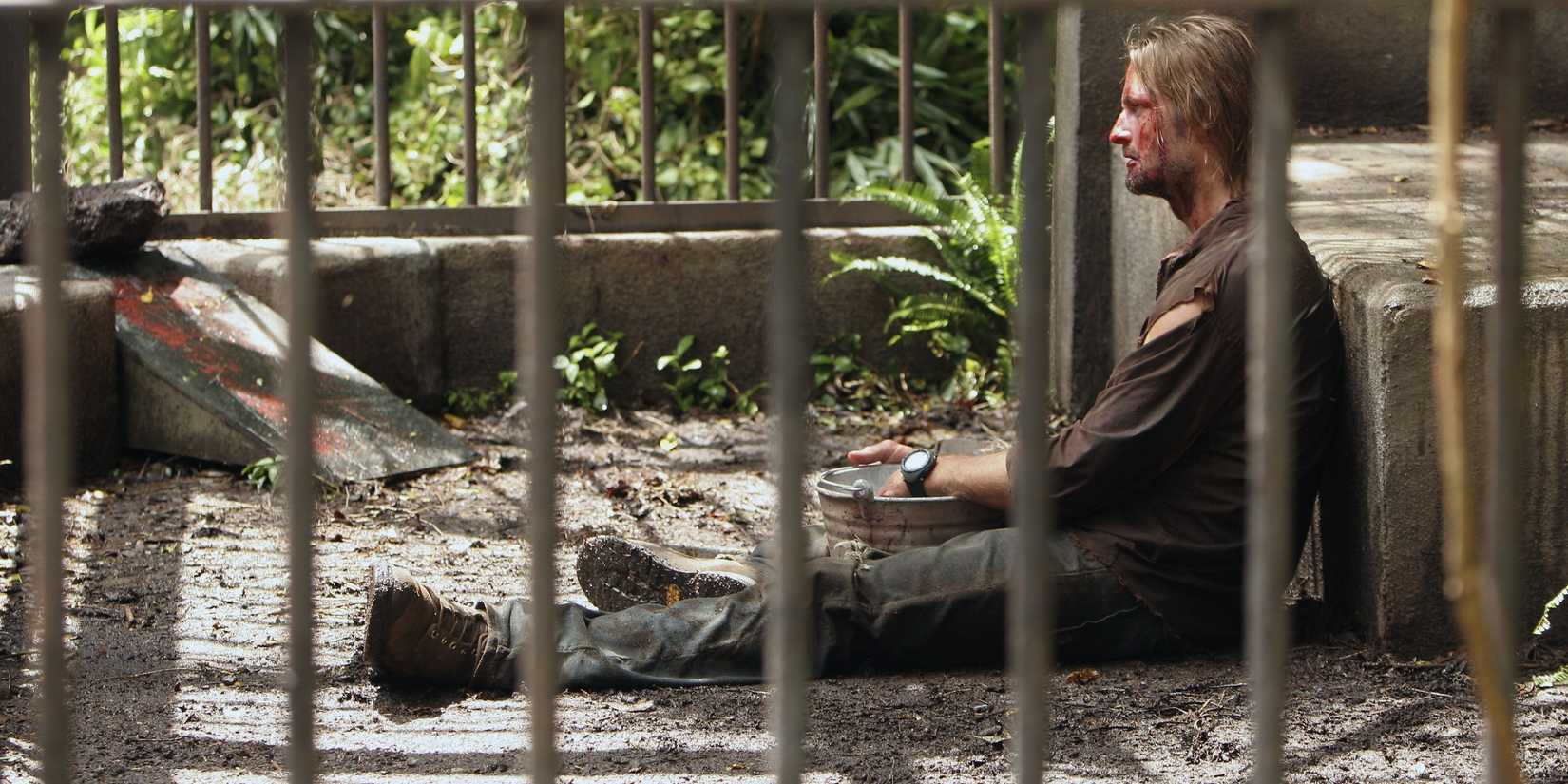 James Sawyer in Lost, sitting defeated in the polar bear cage