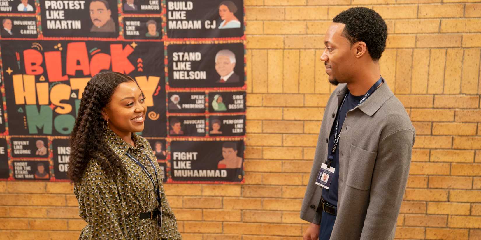 Janine and Gregory smile at each other in the hallway of Abbott Elementary