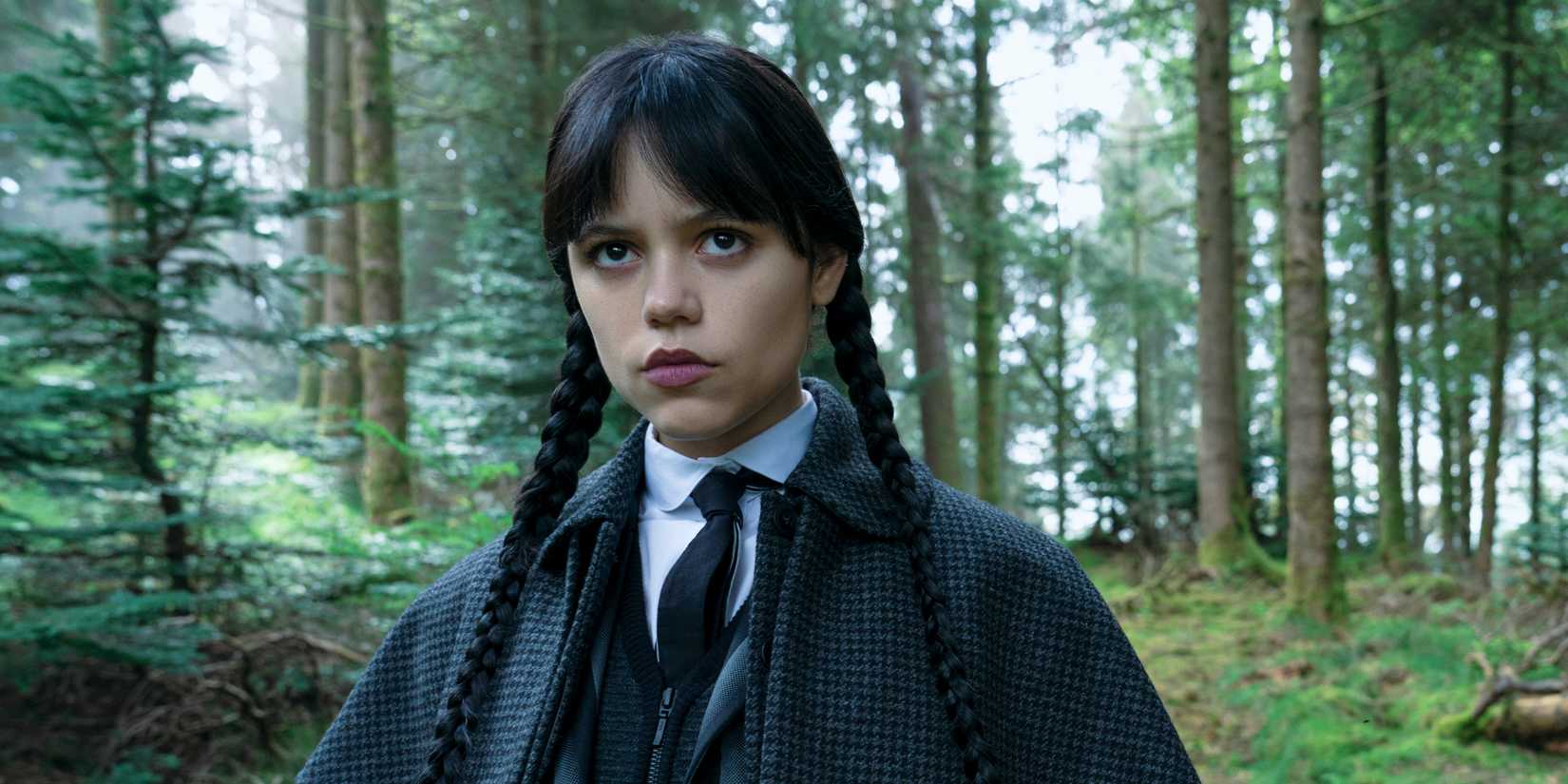 Jenna Ortega as Wednesday standing in the woods in Wednesday season 2