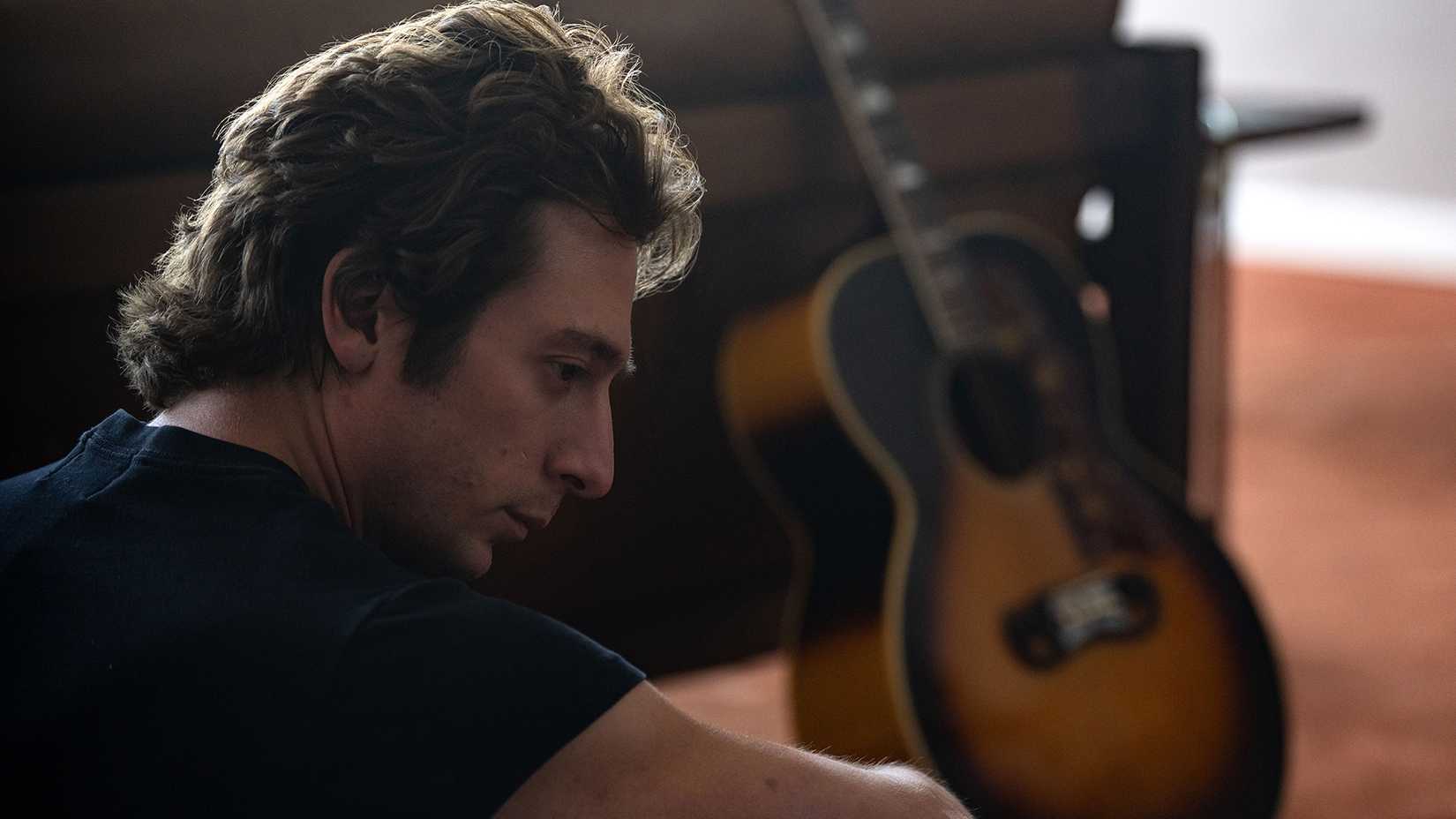 Jeremy Allen White as Bruce Springsteen with Guitar in Deliver Me From Nowhere