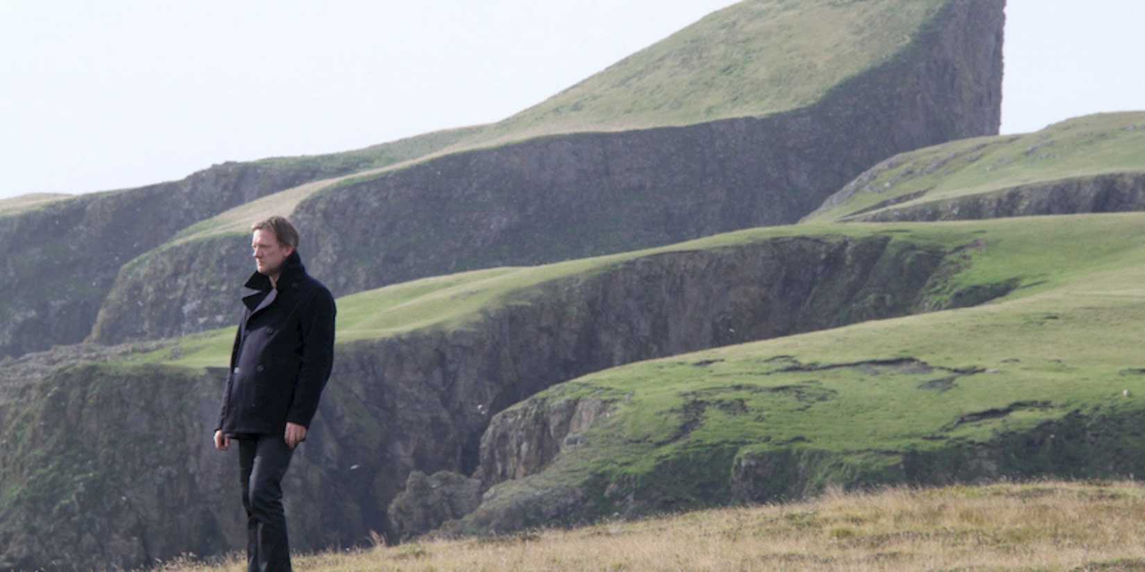 Jimmy Perez standing by a cliff in Shetland