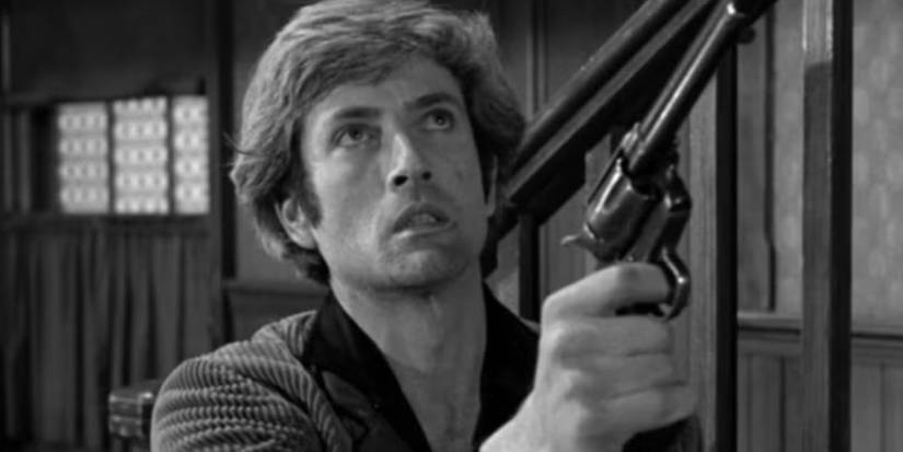 John Drew Barrymore como Mace Gore apontando uma arma em