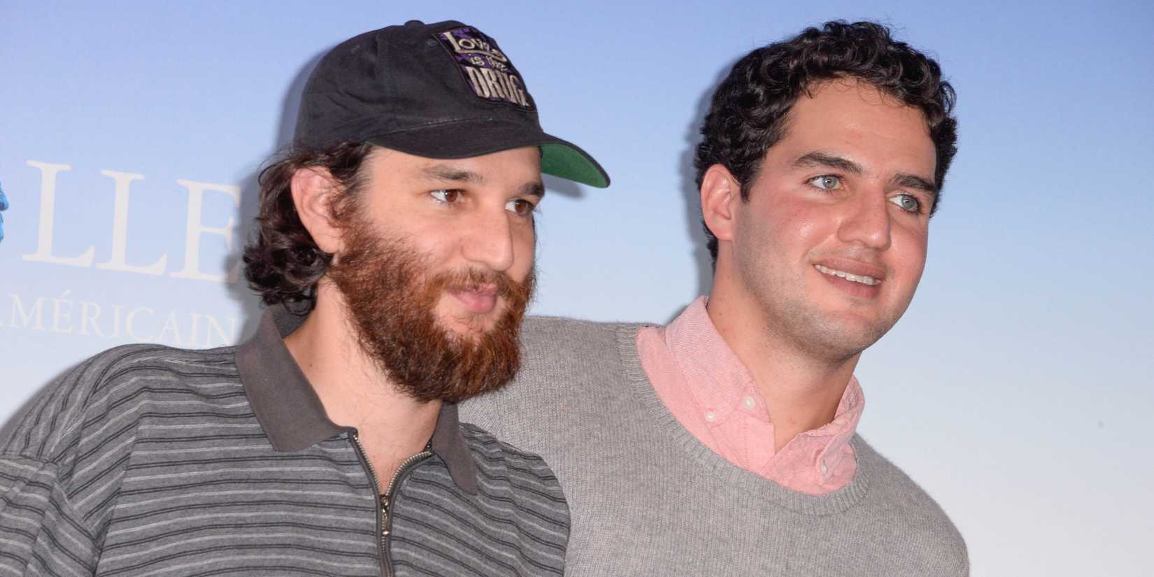Josh and Benny Safdie smiling together at a red carpet event