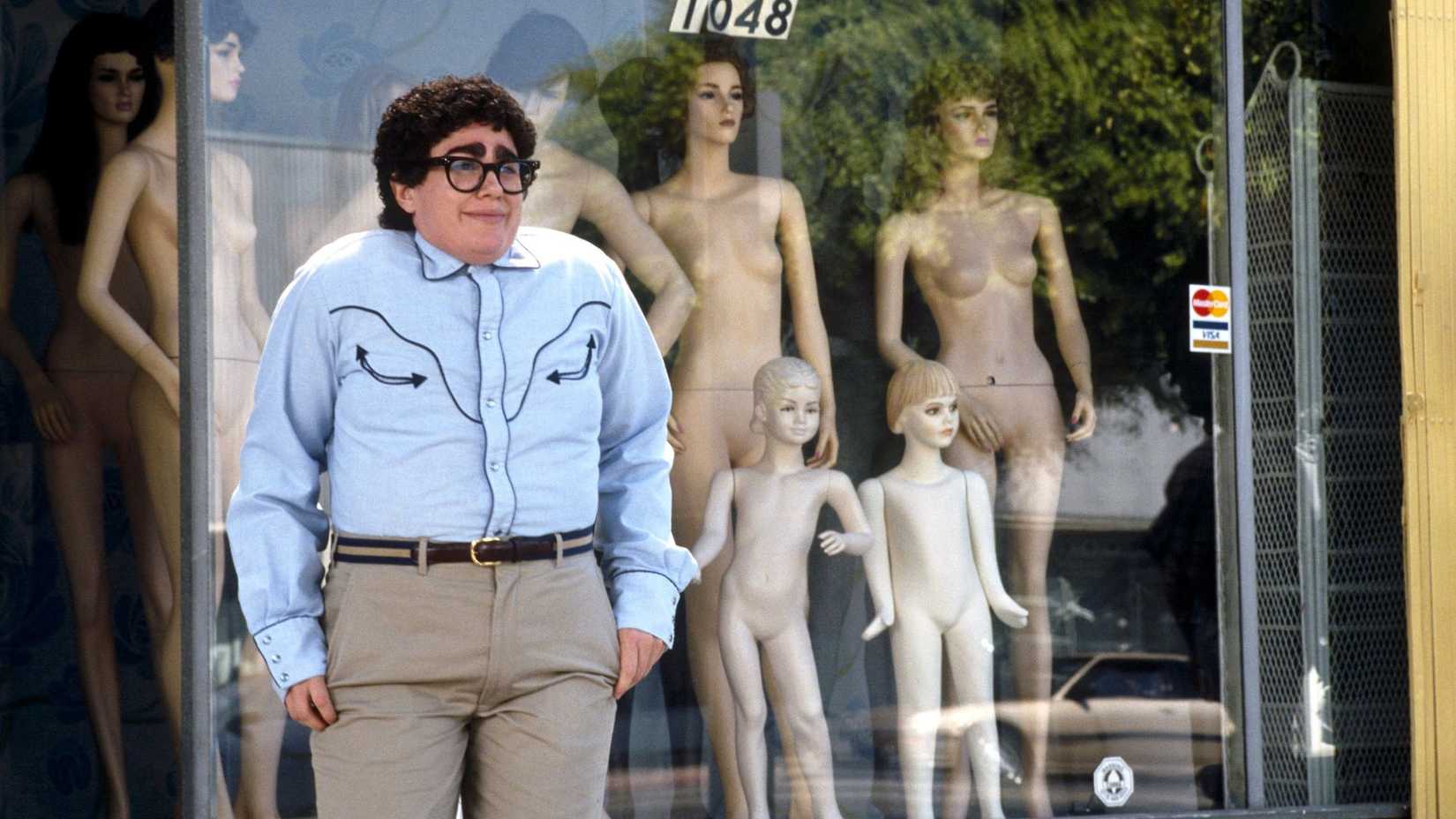 julia sweeny as pat standing in front of mannequins in it s pat