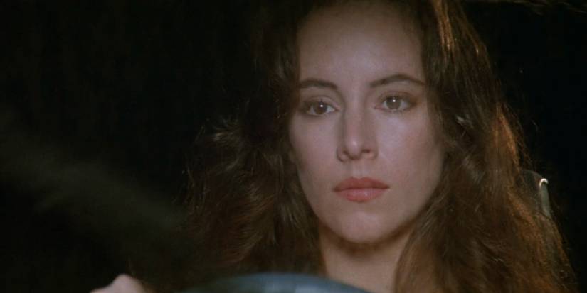 Madeleine Stowe looks pensive while driving in a scene from China Moon