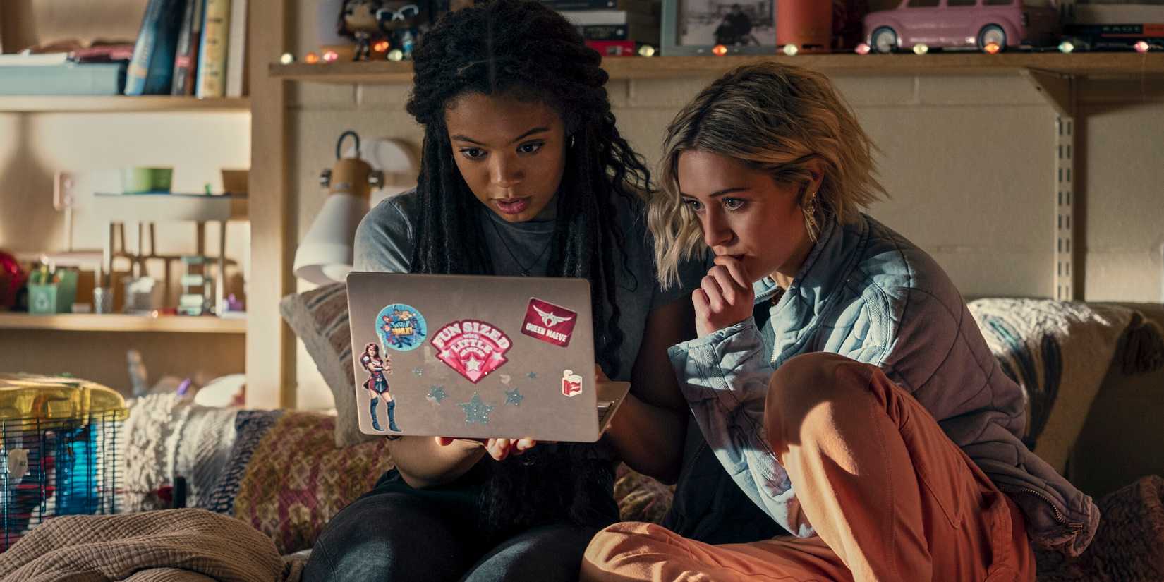 Marie and Emma looking at a laptop in Gen V