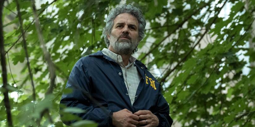 Mark Ruffalo as Tom standing in the woods in Task