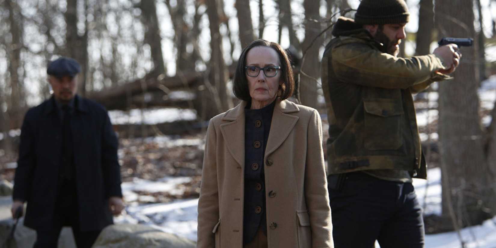 Mr. Kaplan in the woods with armed men in The Blacklist