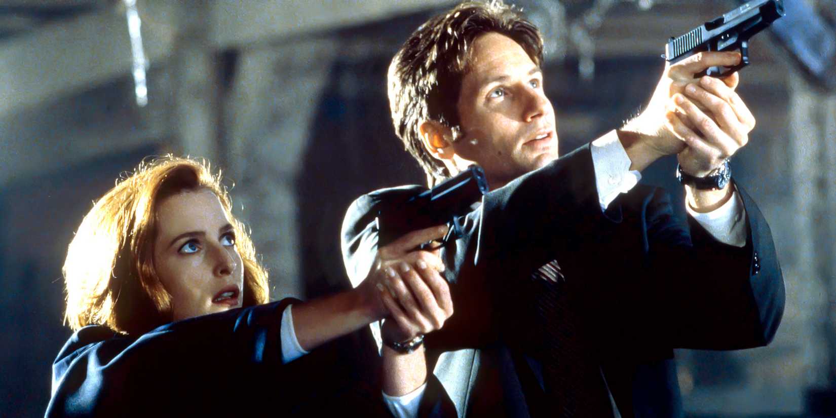 7 Sci-Fi TV Shows That Have Stood the Test of Time 1 Mulder and Scully aiming their guns upwards at something in The X-Files